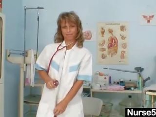 Skinny milf senior nurse toys her pussy on gynochair